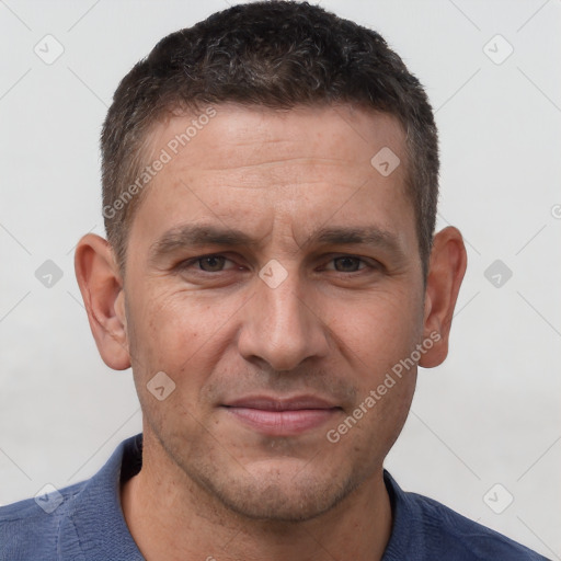 Joyful white adult male with short  brown hair and brown eyes