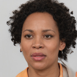 Joyful black adult female with short  brown hair and brown eyes