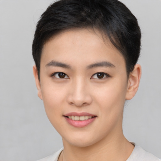 Joyful asian young-adult female with short  brown hair and brown eyes