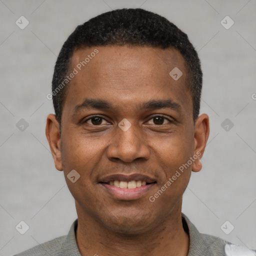 Joyful black young-adult male with short  black hair and brown eyes