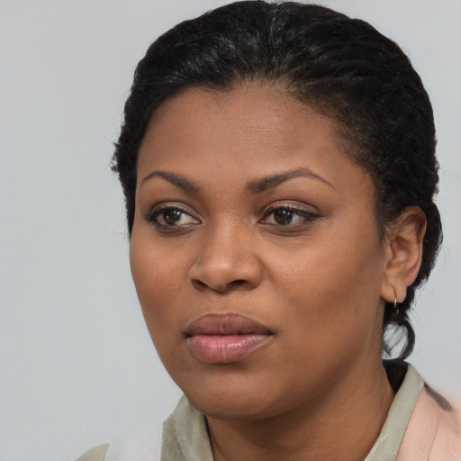 Joyful black young-adult female with medium  black hair and brown eyes