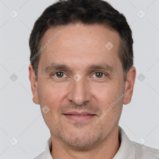 Joyful white adult male with short  brown hair and brown eyes