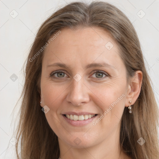 Joyful white adult female with long  brown hair and grey eyes