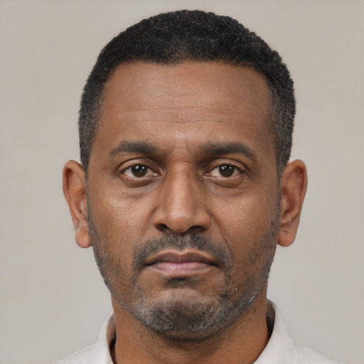 Neutral latino adult male with short  black hair and brown eyes