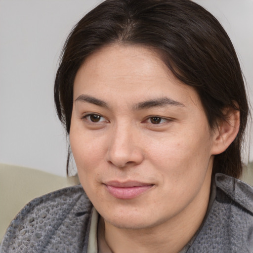 Joyful asian young-adult female with medium  brown hair and brown eyes