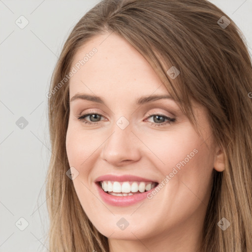 Joyful white young-adult female with long  brown hair and grey eyes