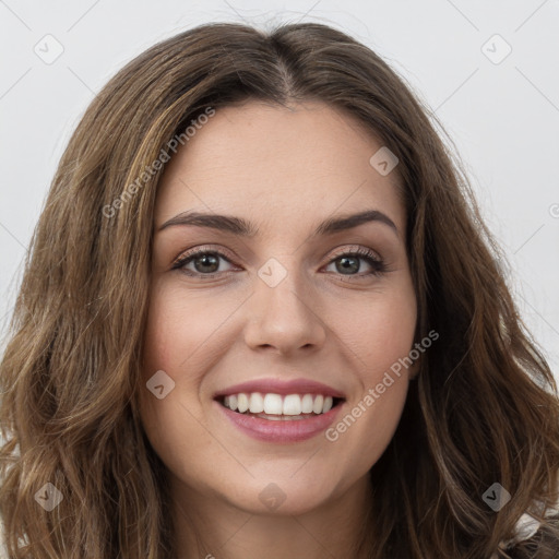 Joyful white young-adult female with long  brown hair and green eyes