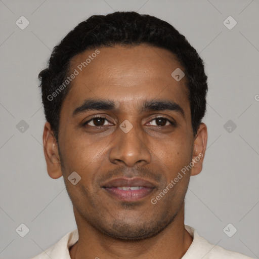 Joyful black young-adult male with short  black hair and brown eyes