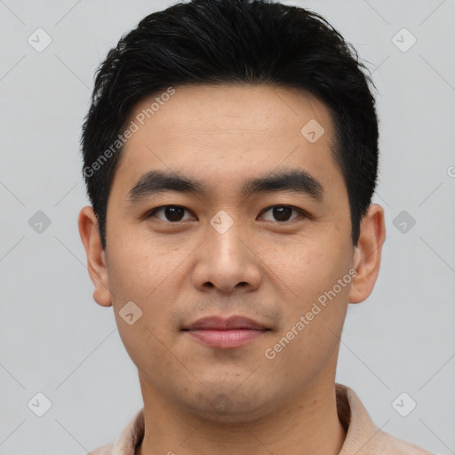 Joyful asian young-adult male with short  black hair and brown eyes