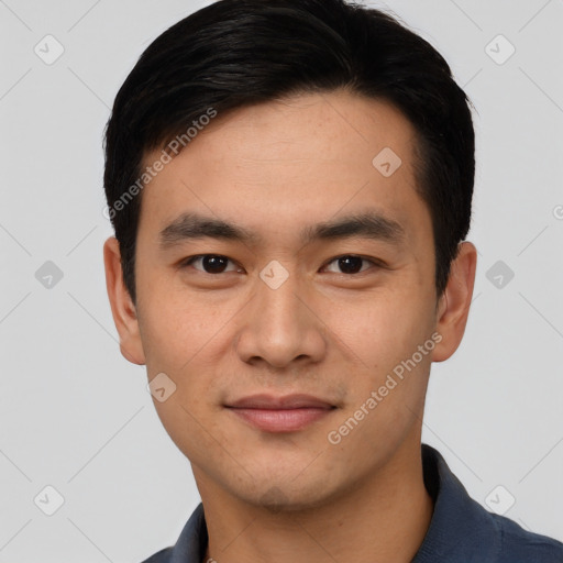 Joyful asian young-adult male with short  black hair and brown eyes