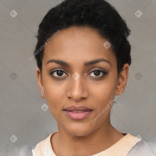 Joyful black young-adult female with short  black hair and brown eyes