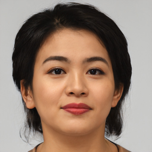 Joyful asian young-adult female with medium  black hair and brown eyes