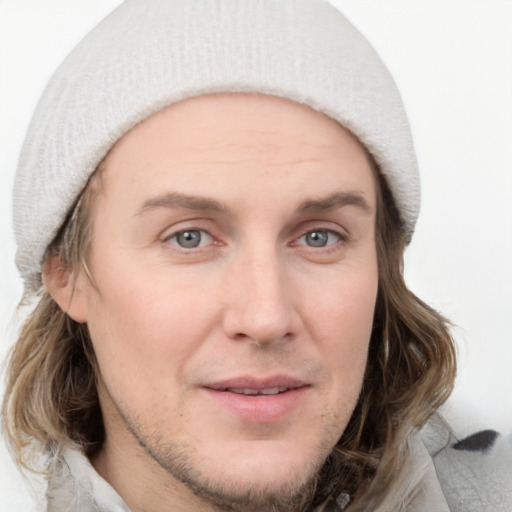 Joyful white young-adult male with medium  brown hair and grey eyes