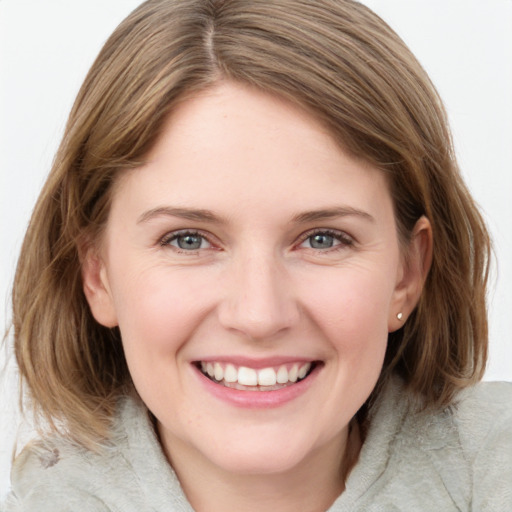 Joyful white young-adult female with medium  brown hair and blue eyes