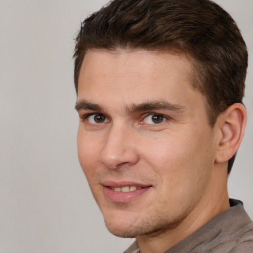 Joyful white adult male with short  brown hair and brown eyes