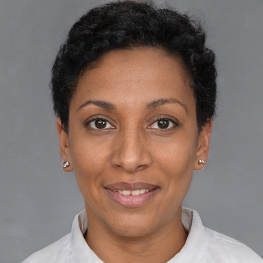 Joyful black young-adult female with short  black hair and brown eyes