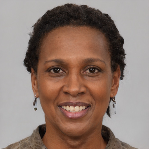 Joyful black adult female with short  brown hair and brown eyes
