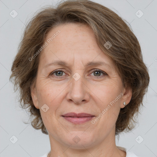 Joyful white adult female with medium  brown hair and grey eyes