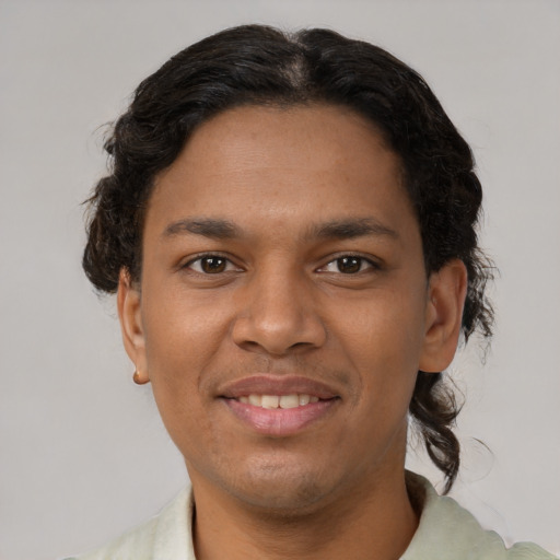 Joyful latino young-adult male with short  brown hair and brown eyes