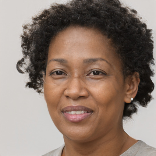 Joyful black adult female with short  brown hair and brown eyes
