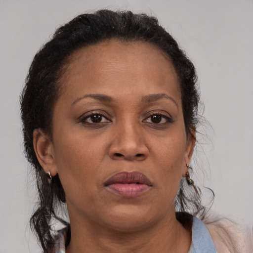 Joyful black adult female with medium  brown hair and brown eyes