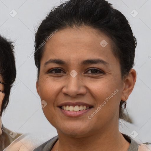 Joyful latino young-adult female with medium  brown hair and brown eyes