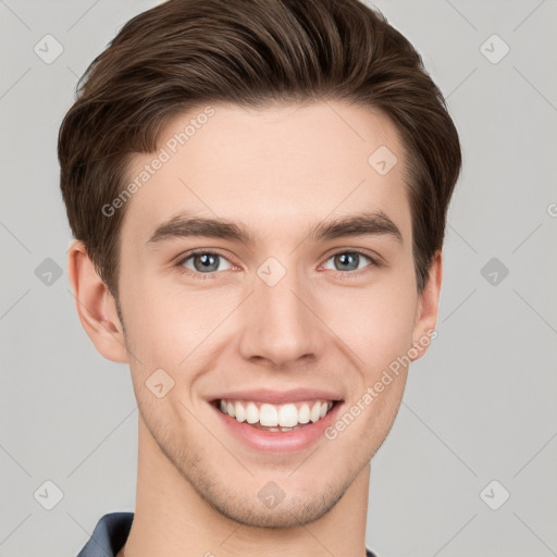 Joyful white young-adult male with short  brown hair and grey eyes