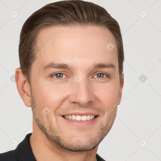 Joyful white young-adult male with short  brown hair and grey eyes