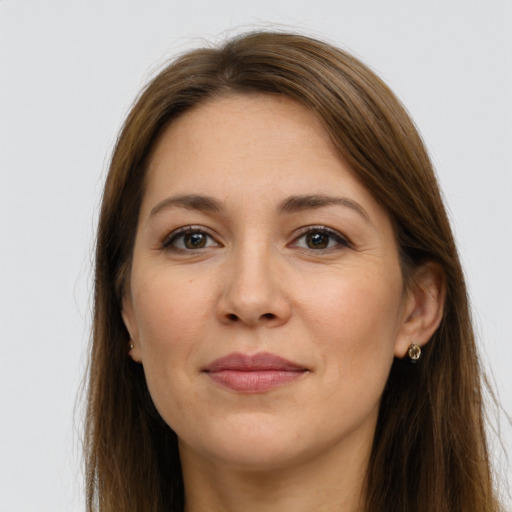 Joyful white young-adult female with long  brown hair and grey eyes