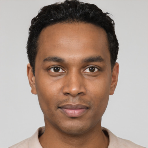 Joyful black young-adult male with short  black hair and brown eyes