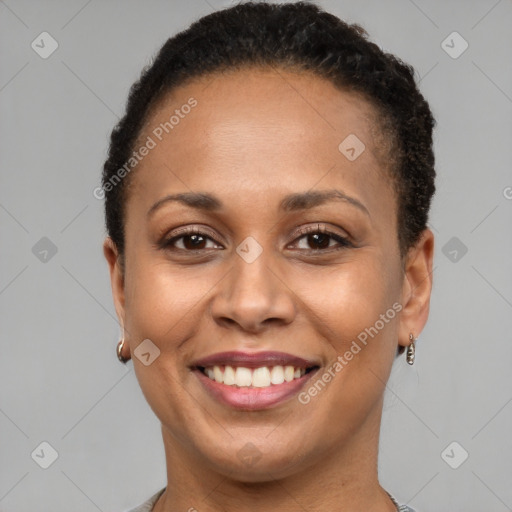 Joyful black adult female with short  brown hair and brown eyes