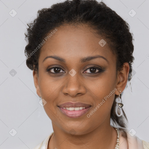 Joyful black young-adult female with long  brown hair and brown eyes