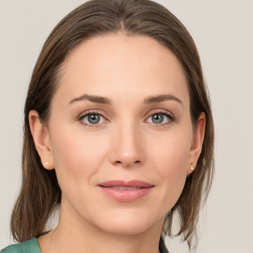 Joyful white young-adult female with medium  brown hair and grey eyes