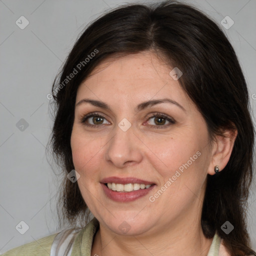 Joyful white adult female with medium  brown hair and brown eyes