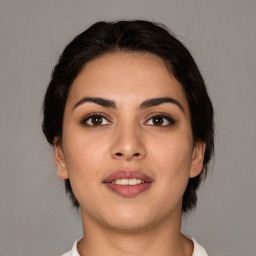 Joyful white young-adult female with medium  brown hair and brown eyes