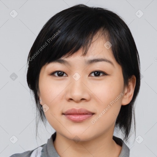 Joyful asian young-adult female with medium  black hair and brown eyes