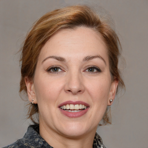 Joyful white adult female with medium  brown hair and blue eyes