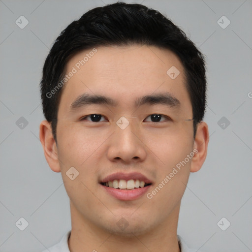 Joyful asian young-adult male with short  black hair and brown eyes