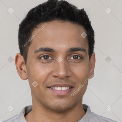 Joyful latino young-adult male with short  brown hair and brown eyes