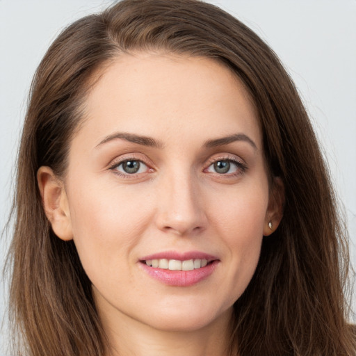 Joyful white young-adult female with long  brown hair and grey eyes