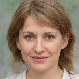 Joyful white young-adult female with medium  brown hair and blue eyes