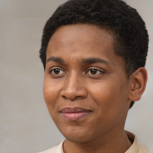 Joyful black young-adult male with short  brown hair and brown eyes