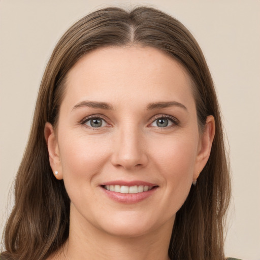 Joyful white young-adult female with long  brown hair and grey eyes