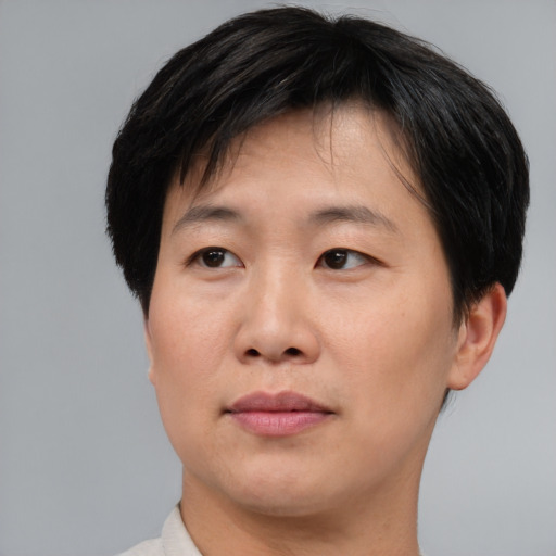Joyful asian adult female with short  brown hair and brown eyes