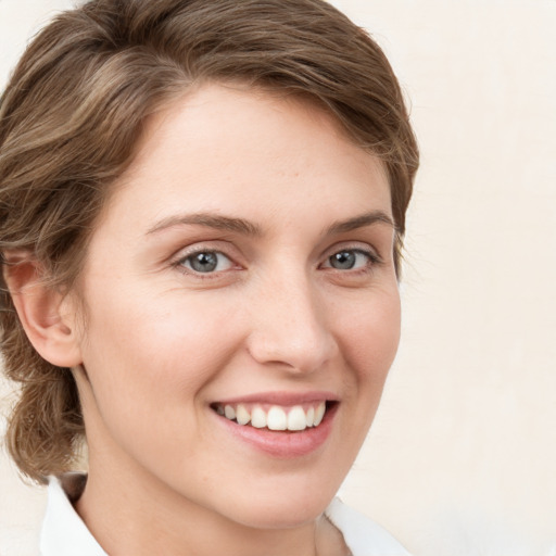 Joyful white young-adult female with medium  brown hair and green eyes