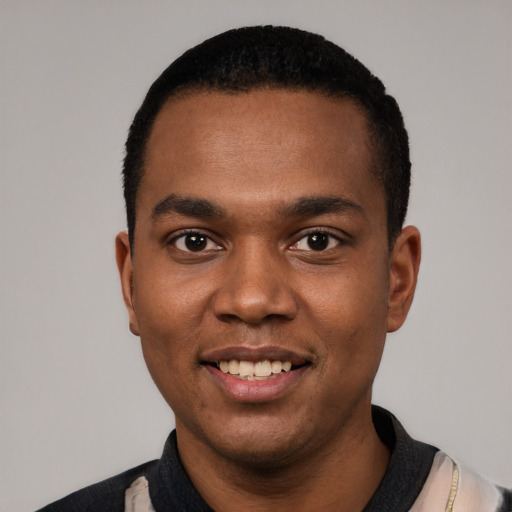 Joyful black young-adult male with short  black hair and brown eyes