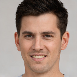 Joyful white young-adult male with short  brown hair and brown eyes