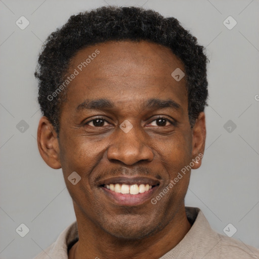 Joyful black adult male with short  black hair and brown eyes