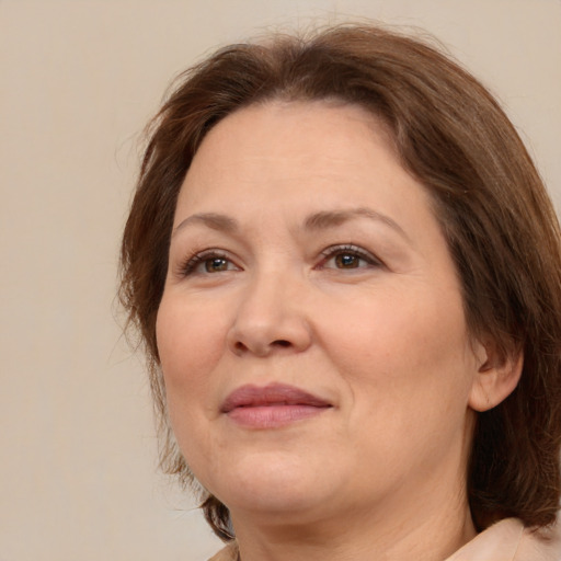 Joyful white adult female with medium  brown hair and brown eyes