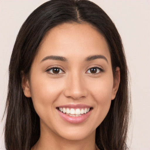 Joyful white young-adult female with long  brown hair and brown eyes